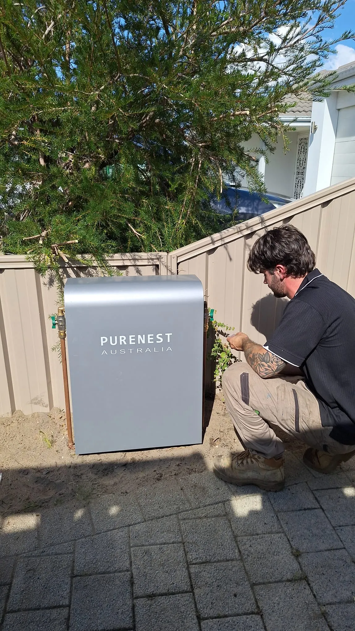 Licensed plumber installing a Purenest Australia whole-home filtration system